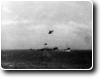 HMAS Australia downs two Japanese bombers as a third flies over.
